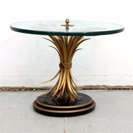 Vintage Glass Top Gold Tone Italian Wheat Sheaf Side Table: A vintage Italian gold tone wheat sheaf side table. This table has a round glass top supported by a brass tone metal wheat sheaf. It rests upon a two-tiered, round wooden base with a black-painted finish and brass tone accents.