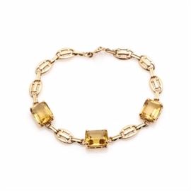 14K Yellow Gold Citrine Link Bracelet: A 14K yellow gold citrine link bracelet. This bracelet features three emerald cut citrine, which are linked with an alternating combination of a yellow gold rectangular link and a yellow gold oval openwork link.
