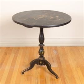 Tole Print Tilt-Top Table: A vintage tilt-top table. The dark stained wooden piece has a circular top that tilts and secures vertically or horizontally, set on a turned pedestal and three curved legs. The table top and pedestal have an elaborate floral design in yellows, blues, reds, oranges, purples, creams, and greens.