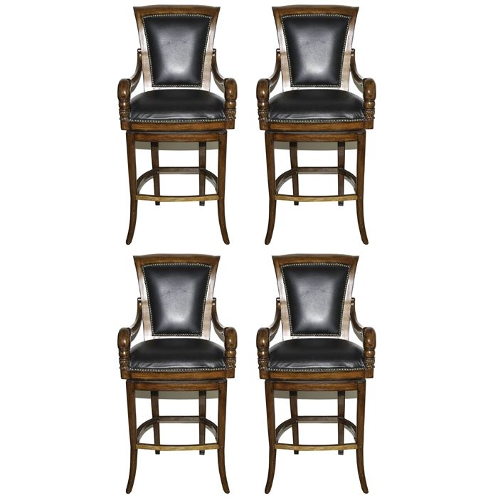 Black Leather Swivel Bar Stools: A set of four black leather swivel bar stools. The wooden bar stools have curved arms with carved leaf detailing to the front. They have black leather seats and backs with nailhead trim to the seat backs and front and back of the chairs. There are no maker identifications.