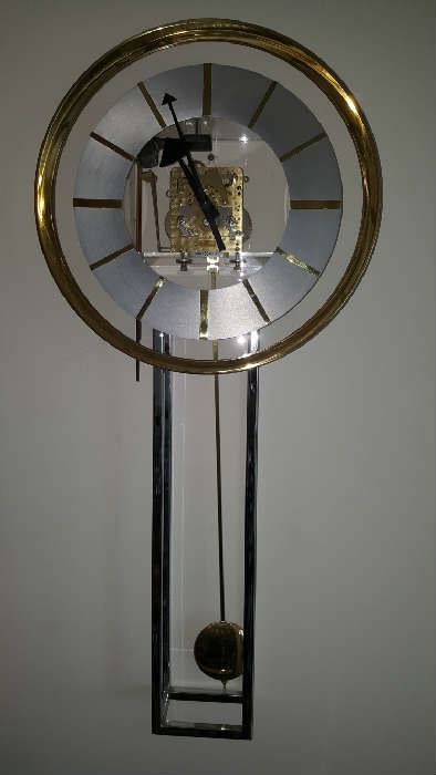 glass and chrome Howard Miller wall clock with exposed gears Designed by George Nelson.