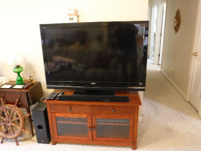 Large TV dated 2010 in wonderful condition. The stand is a beauty and separately priced as is the Woofer and sound bar. But a package deal can be had!
