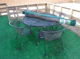 Metal table with 4 chairs and also a nicer umbrella with stand