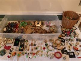 Lots of clip-on earrings. The woman did not have pierced ears. Most of this jewelry in these totes and baskets is priced under $5 each to $1.