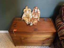 Small cedar trunk with 2 Venetian dolls on top. The cover to the trunk needs a couple of screws