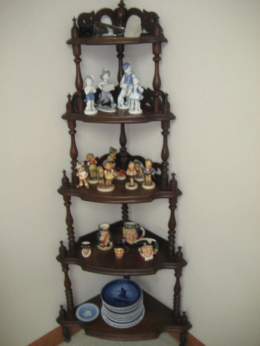 Corner cabinet with Hummels, Toby mugs, German figurines, Royal Copenhagen plates