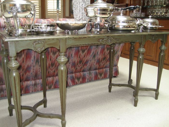 Sofa table with silverplate serving pieces