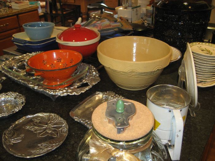 Oversized stoneware bowl, antique cookie cutter, orange colander, vintage flour sifter