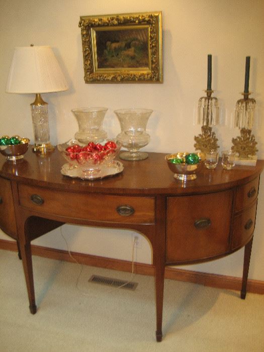 Curved vintage buffet with crystal accessories and antique oil painting
