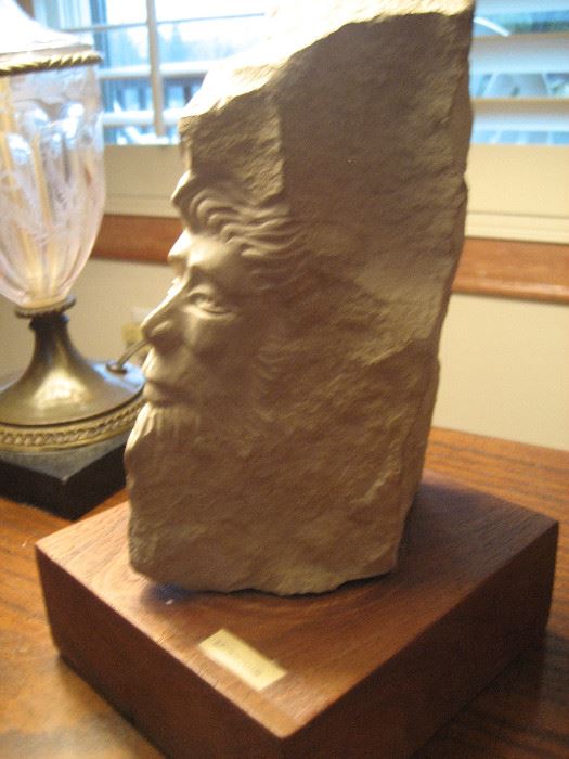 Carved stone table sculpture titled "Leprechaun"