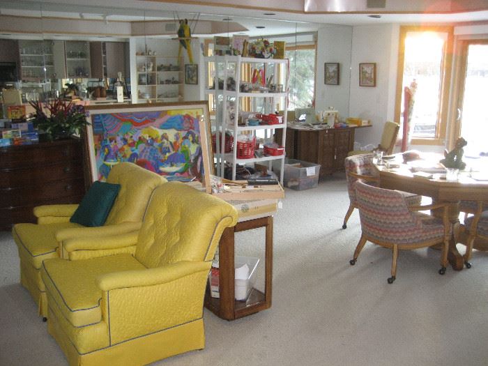 Pair of yellow upholstered chairs, game table, sewing supplies
