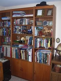More Teak shelves, varied genre of books and collectibles.