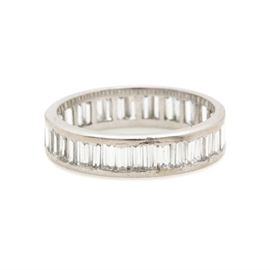 Platinum Diamond Eternity Ring: A platinum diamond eternity ring. Baguette cut diamonds are set in a continuous line around this band ring.