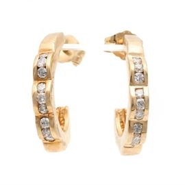14K Yellow Gold Diamond J- Hoop Earrings: A pair of 14K yellow gold diamond j-hoop earrings. These earrings feature channel set diamonds and have a scalloped profile view.