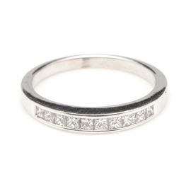 18K White Gold Diamond Ring: An 18K white gold diamond ring with a half channel of diamonds.
