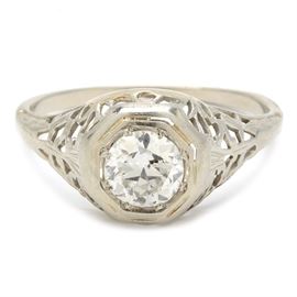 Vintage 18K White Gold Diamond Solitaire Engagement Ring: A vintage 18K white gold diamond solitaire engagement ring featuring a transitional cut diamond in a pierced filigree setting.