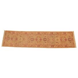 Hand-Knotted Pakistani Carpet Runner: A hand-knotted Pakistani carpet runner. This rug features a maroon and brown palette of palmettes and serrated leaf forms on a tan background. It has a matching primary border, with double overcast selvedge and dense, natural cotton warp fringe to each end. There are no evident tags or markings.