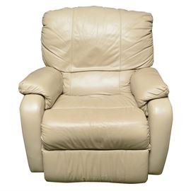 Leather Recliner: A leather recliner. This recliner features a light beige leather upholstery. The lever to recline is located on the lower right side of the chair. There are no evident tags or markings.