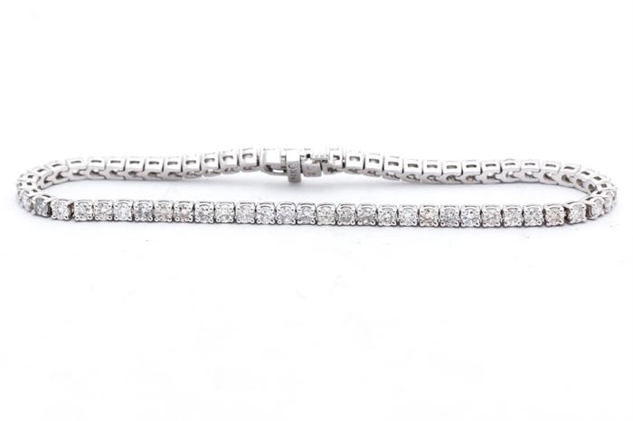 14K White Gold 3.75 CTW Diamond Bracelet: A 14K white gold tennis bracelet of basket prong set round cut diamonds.