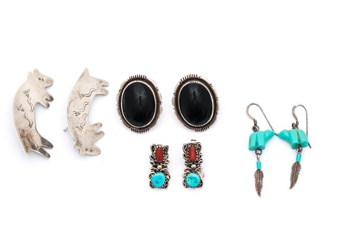 Sterling Silver Southwestern Style Earrings: A set of sterling silver Southwestern style earrings including a pair of engraved bear shaped earrings, a pair of oval cabochon black onyx earrings, a pair of turquoise and coral earrings, and a pair of dangle earrings with bear carved beads.
