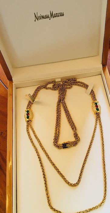 Handmade Van Cleef & Arpel necklace, made in Paris, contained two woven strands of 18K gold and two jeweled stations containing 1.95 carats of cabochon rubies, 2.75 carats of cabochon emeralds, and 2.39 carats of round diamonds. 30" in length