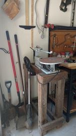 Woodworking saw, shovel, weed eater, rake, workbench,