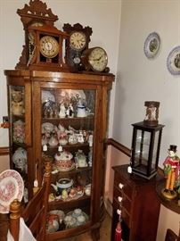 antique display cabinet with mantle clocks, 