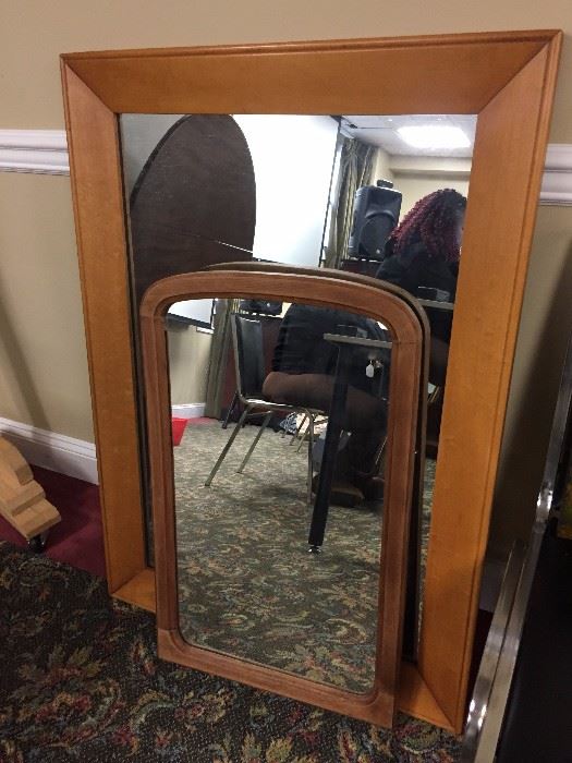 1 vintage and 1 Mid-Century Modern hanging mirrors.