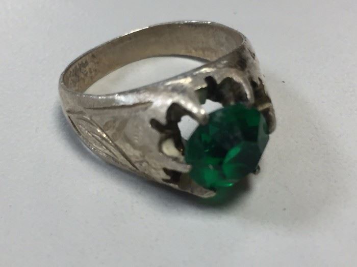 Sterling silver ring with green gemstone.