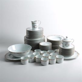 Bernardaud Limoges "Bel Ami" Porcelain Tableware: A twelve serving set of Bernardaud Limoges porcelain tableware including dinner plates, salad plates, dessert plates, soup bowls, flat cups, saucers, two serving platters, a serving bowl, a lidded sugar bowl, and a creamer pitcher. The pieces feature the Bel Ami pattern with bright purple, green, yellow, and red foliate borders and gilt accents. The pieces are marked “Bernardaud Limoges France” to the underside and the discontinued pattern was produced between 1985-1998.