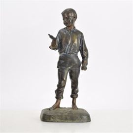 Circa 1920's Brass-Tone Sculpture of Boy: A brass-tone sculpture of a boy circa 1920’s. This sculpture depicts a standing, barefoot boy staring at his right palm. It is balanced on an integrated base stamped “Germany”.