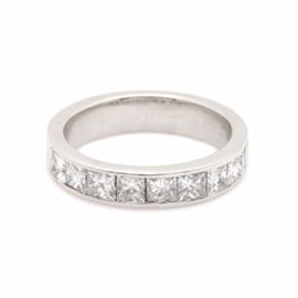 Platinum 1.28 CTW Diamond Ring: A platinum 1.28 ctw diamond ring. This ring showcases nine princess cut diamonds adorned across the flush designed setting.