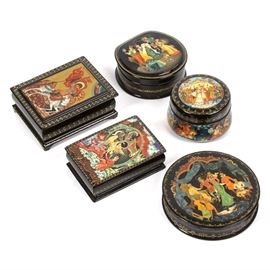 Five Black Lacquer Legend and Fairy Tale Boxes: A collection of five wooden lacquer boxes depicting scenes from legends and fairy tales. This lot includes three round boxes and two rectangular boxes, including one with an image of St. George slaying the dragon, with a Greek caption to the top.
