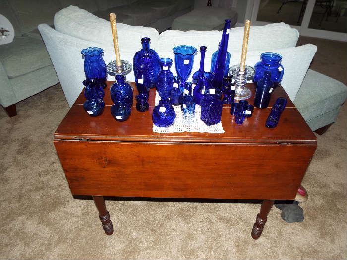 Nice drop-leaf table with lots of cobalt glass