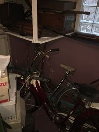 2 vintage bikes. We can't get close enough to see the makers. When we can I will be sure & post the info.- I believe the red bike is an Elgin. We are getting closer to them... woo hoo!!!
