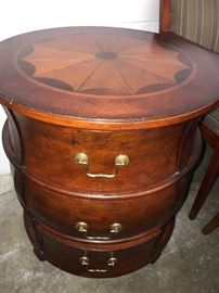 Round decorative three-drawer dresser with inlaid design top by Butler.