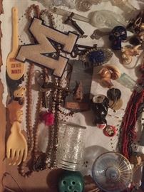 display case items, including many vintage perfume bottles, Jumbo (miniature) glass peanut butter jar, beads, etc.