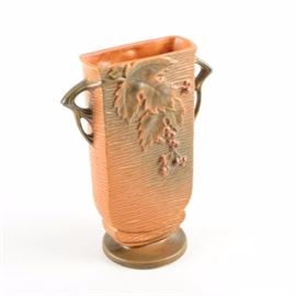 Roseville "Bushberry" Vase: A Roseville Bushberry vase.This design was introduced in 1941 and features three-section oak leaves with sawtooth edges and berries on an orange line textured background. The handles of this urn are branch shaped and the base of this piece reads, “Roseville, USA 36-9”.