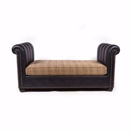 Contemporary Chesterfield Récamier: A contemporary faux black leather chesterfield récamier having two channeled, rolled arms and nailhead trim between an upholstered seat. The rectangular, removable seat cushion is covered in a taupe, black and ivory print fabric with a piped trim. The piece rises on bun feet joined by a covered button accented bottom rail.