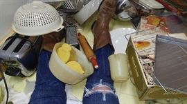 May sitting in the kitchen floor after I pulled all the stuff out from under the cabinets