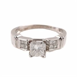 14K White Gold 1.26 CTW Diamond Ring: A 14K white gold 1.26 ctw diamond ring. This ring features a center diamond above an open gallery set between channel set diamond shoulders.