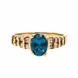 14K Yellow Gold Spinel and Cubic Zirconia Ring: A 14K yellow gold synthetic spinel and synthetic cubic zirconia ring. This ring features a center, prong set synthetic spinel flanked by invisible set cubic zirconia stones along the tapered shoulders.
