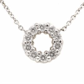 14K White Gold Diamond Circle Necklace: A 14K white gold diamond circle necklace. This necklace features an open circle pendant, set with diamonds, affixed to a cable link chain.