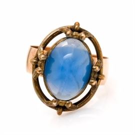 10K Yellow Gold Star Glass Ring: A 10K yellow gold star glass ring. This ring showcases a star glass center adorned to the swirling openwork base metal crown, situated upon the 10K yellow gold shank.