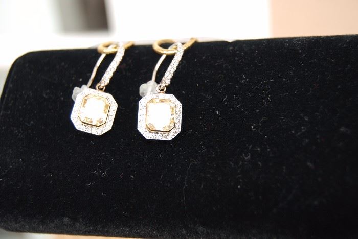 18K pair of fancy yellow radiant cut diamond earrings - 3.07 + 3.22 centers =  6.29 cts tw.  -  set with 58 round diamonds - 1.73 cts - Appraised value =  $71,500  (2013)