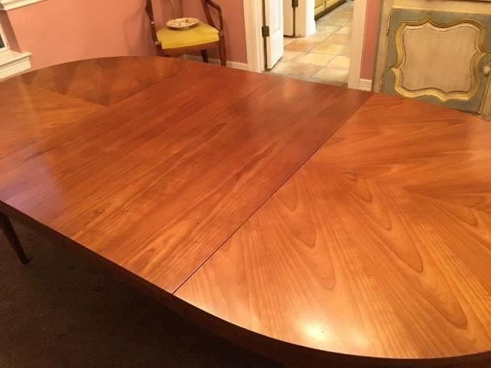 Kindel Oval Table- Top is four pieced matched veneer fruitwood Top closed: 42 x 52. Top open: 42 x 100 (3-16" leaves with apron)