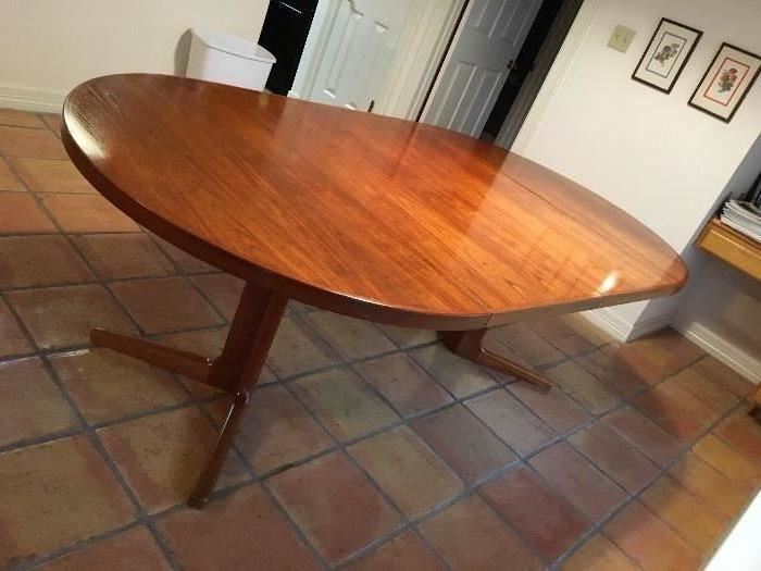 A round to oval vintage Danish Modern teak dining table in excellent condition. Vejle/ made in Denmark.  2 20 " leaves included. measures 86" fully open and would seat 6 -8 comfortably.