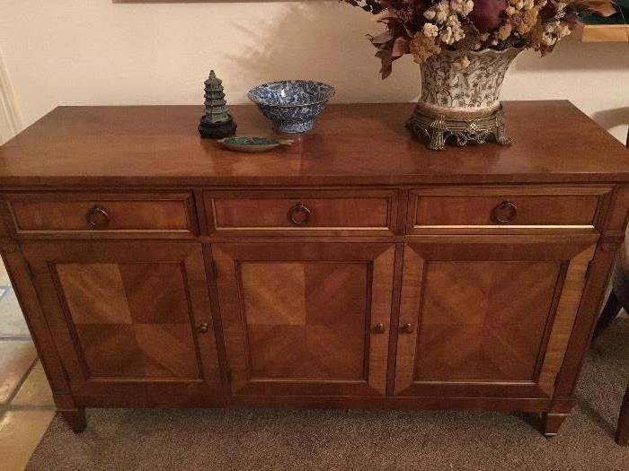 Kindel fruitwood buffet with four piece mached venner Top 56 x 19. Height 33. Center drawer divided with tarnish resistant cloth. Behind the two right hand doors there is a large drawer for linen and a removable shelf.