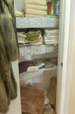 Lots of linens. Full window panels in beige and ivory, valances.