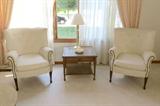 Two sets of wingback chairs